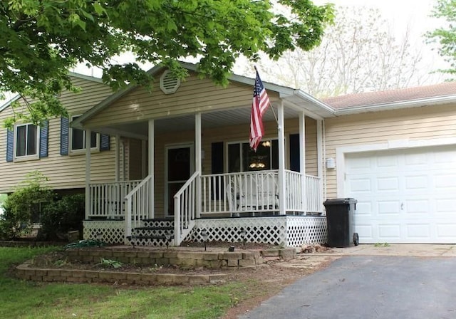 view of front of property featuring a porch and a garage