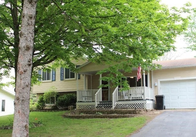 view of front facade with a front lawn, a porch, and a garage