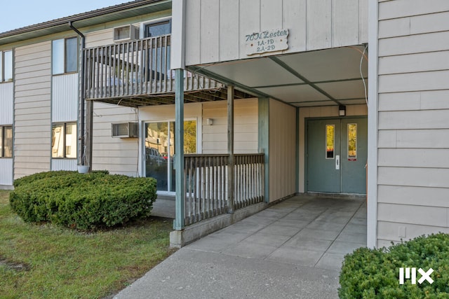 view of exterior entry featuring a wall unit AC