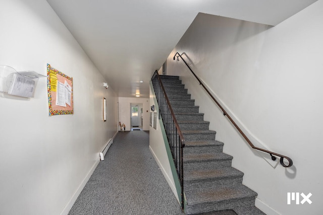 stairway with carpet floors and baseboard heating