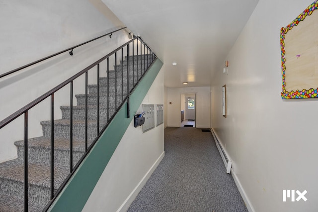 stairway featuring carpet floors and baseboard heating