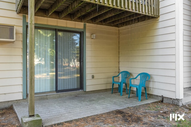 view of patio / terrace with an AC wall unit