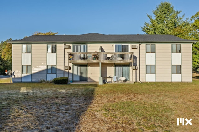 back of property featuring a yard and a deck