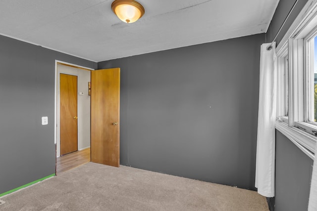 unfurnished bedroom featuring light carpet