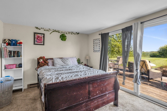 carpeted bedroom with access to exterior and baseboard heating