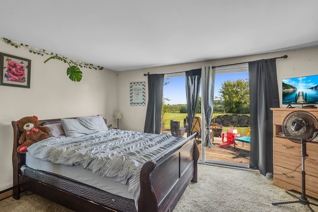 carpeted bedroom with access to outside