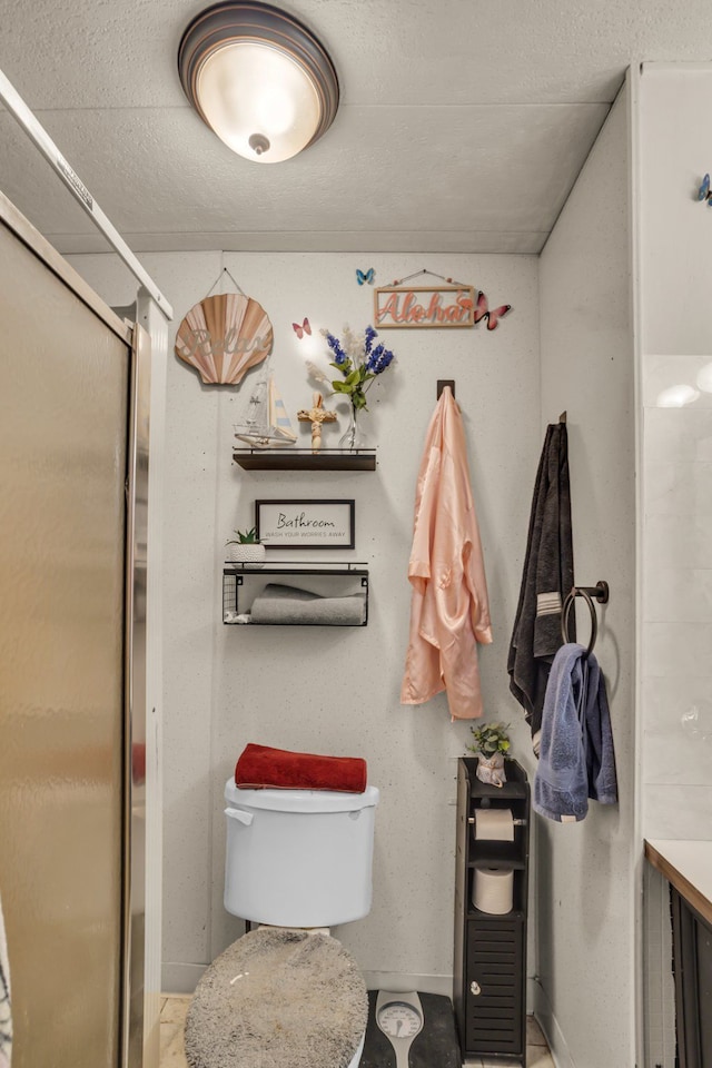 bathroom featuring toilet and walk in shower