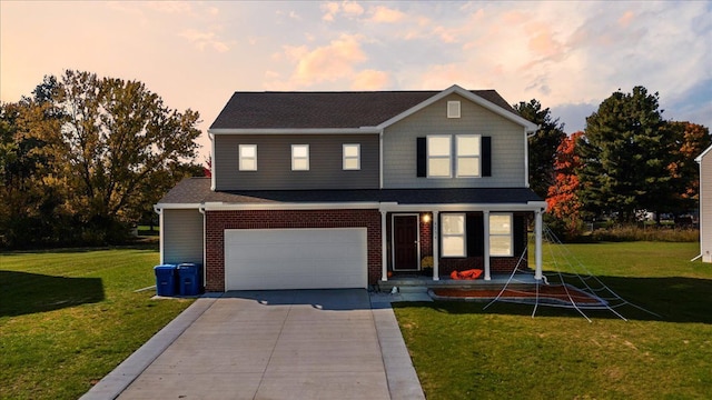 view of front of home featuring a lawn and a garage