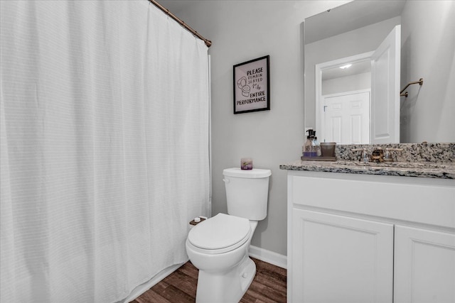 bathroom featuring hardwood / wood-style flooring, vanity, and toilet