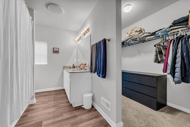 bathroom with vanity and wood-type flooring