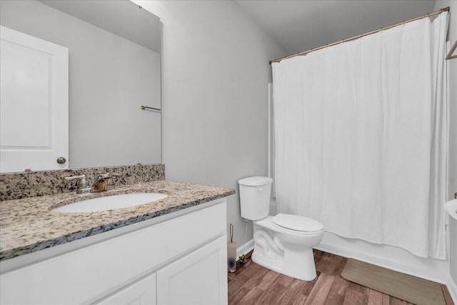 full bathroom with shower / bath combo with shower curtain, toilet, wood-type flooring, and vanity