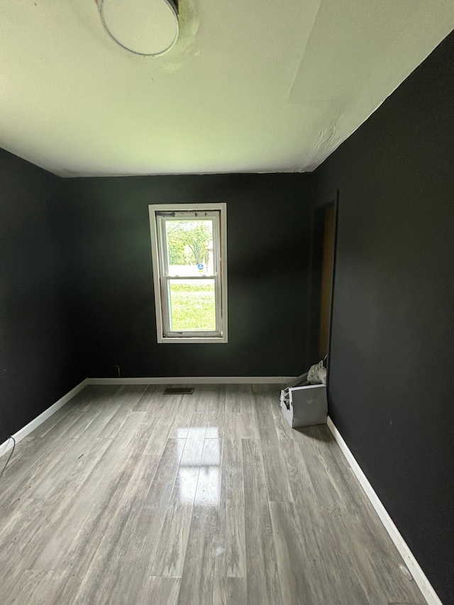 unfurnished room featuring hardwood / wood-style flooring