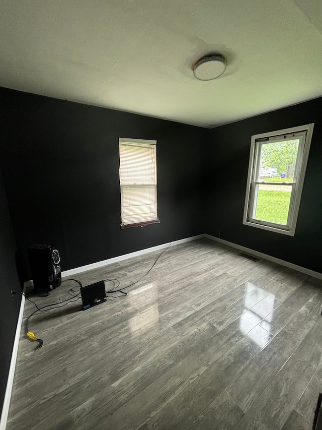 spare room with wood-type flooring