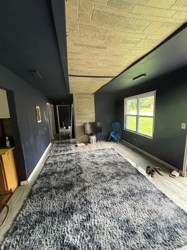 interior space featuring hardwood / wood-style floors and vaulted ceiling