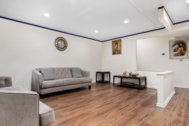 living room with hardwood / wood-style floors and crown molding