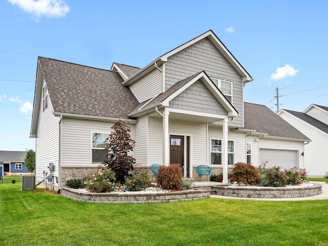 craftsman-style home featuring cooling unit, a garage, and a front lawn