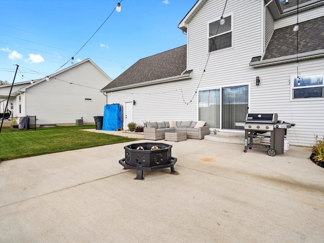 back of house featuring a yard, an outdoor living space with a fire pit, and a patio