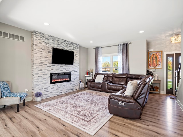 living room with a fireplace and light hardwood / wood-style flooring