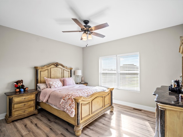 bedroom with ceiling fan and light hardwood / wood-style flooring