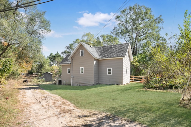 view of property exterior with a yard and central AC