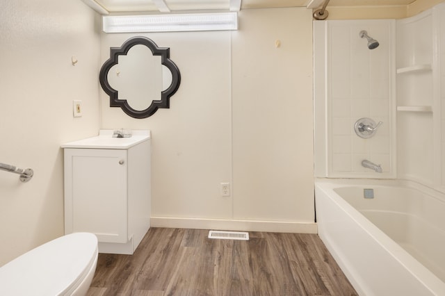 full bathroom with vanity, hardwood / wood-style flooring, toilet, and tub / shower combination