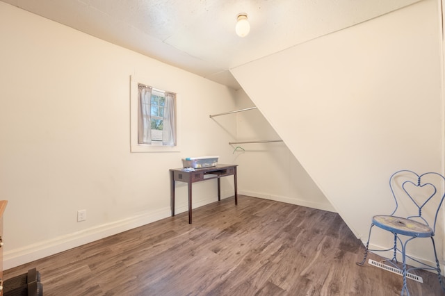 laundry room with wood-type flooring