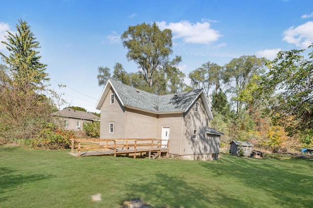 rear view of house with a deck and a yard