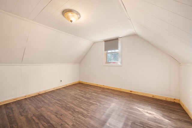 bonus room with hardwood / wood-style floors, wood walls, and lofted ceiling