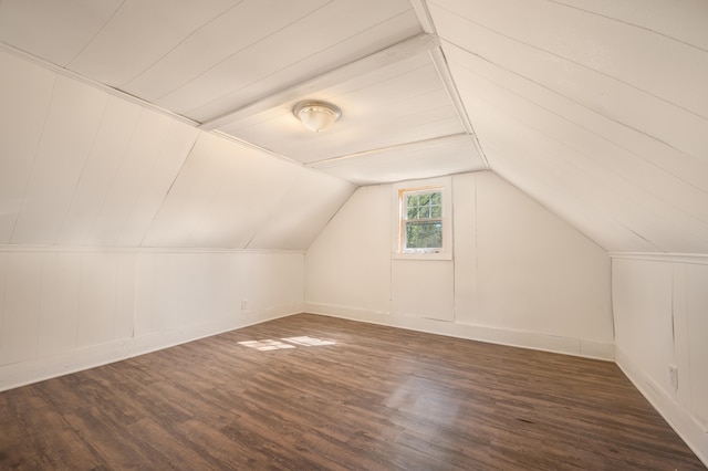 additional living space with dark hardwood / wood-style floors and vaulted ceiling