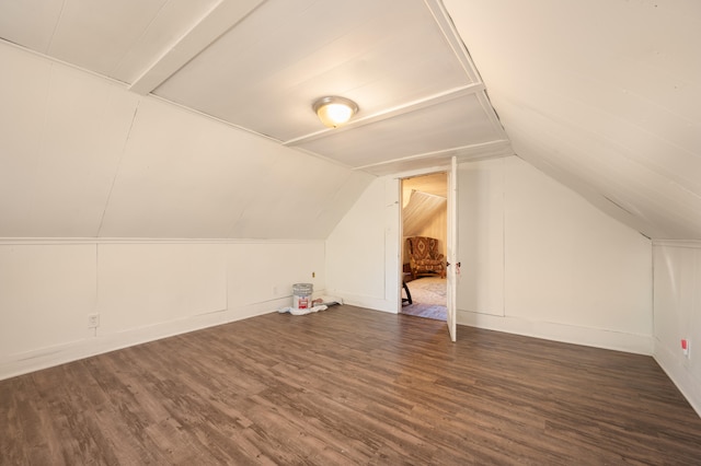 bonus room with dark hardwood / wood-style floors and lofted ceiling