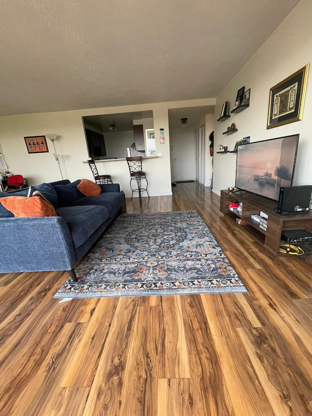 living room with hardwood / wood-style floors and a textured ceiling