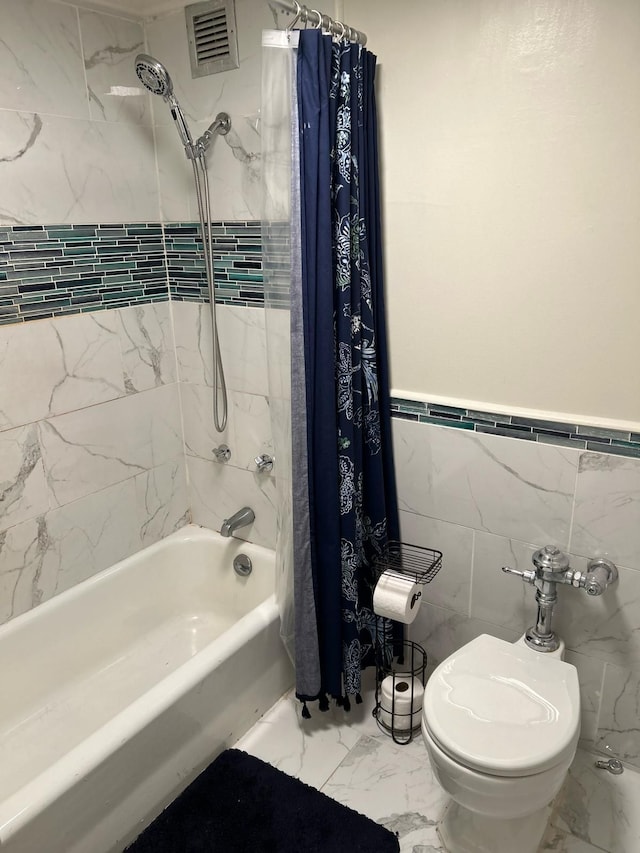 bathroom featuring toilet, tile walls, and shower / tub combo