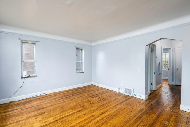 unfurnished room with crown molding and dark wood-type flooring