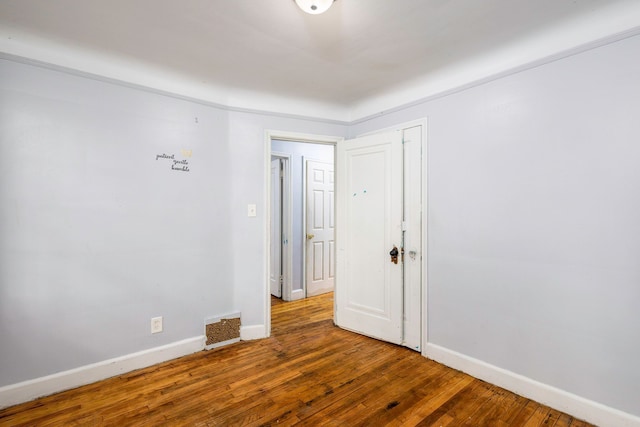 spare room with wood-type flooring