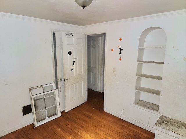 unfurnished room featuring crown molding and dark wood-type flooring