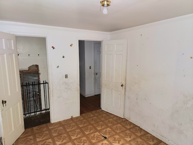 spare room with light parquet flooring and crown molding