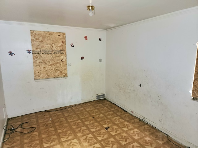 spare room featuring crown molding and light parquet floors