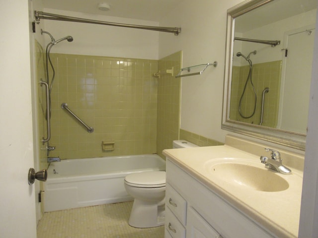 full bathroom featuring toilet, vanity, tile patterned floors, and tiled shower / bath combo