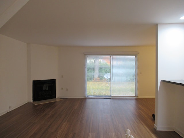 unfurnished living room featuring dark hardwood / wood-style flooring