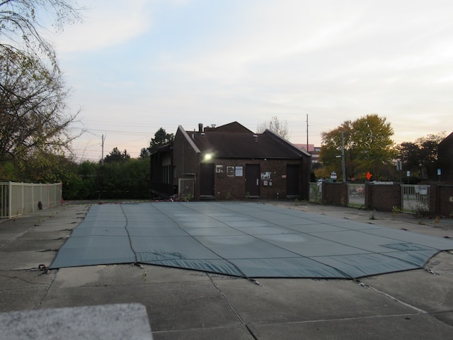 pool at dusk featuring a patio area