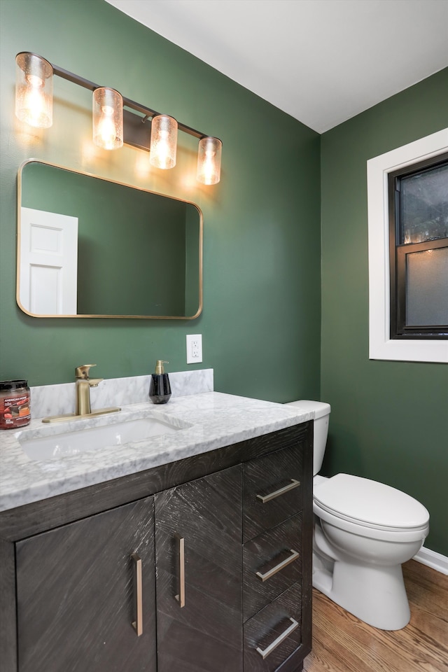 bathroom featuring hardwood / wood-style floors, vanity, and toilet