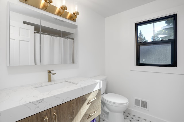 bathroom with vanity and toilet