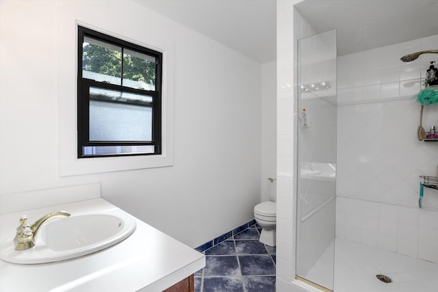 bathroom with tile patterned flooring, vanity, toilet, and walk in shower