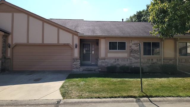 view of front of home featuring a garage and a front yard