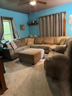 carpeted living room featuring ceiling fan