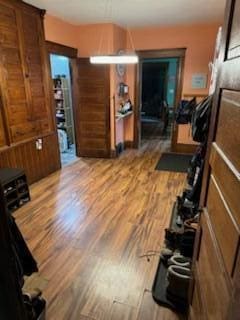 exercise area with wood walls and hardwood / wood-style floors