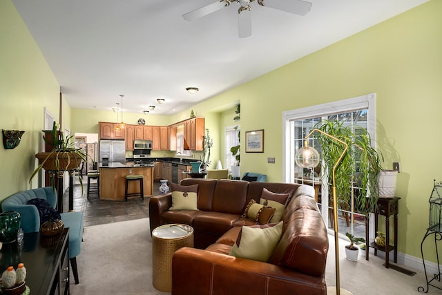 carpeted living room featuring ceiling fan