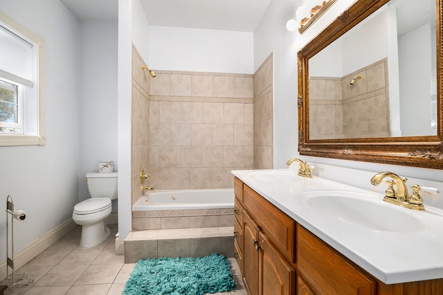 full bathroom with tile patterned floors, tiled shower / bath, vanity, and toilet