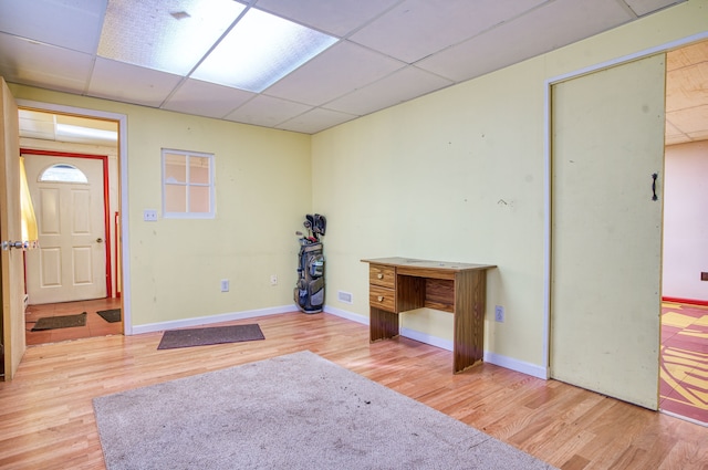 interior space with a paneled ceiling and wood-type flooring