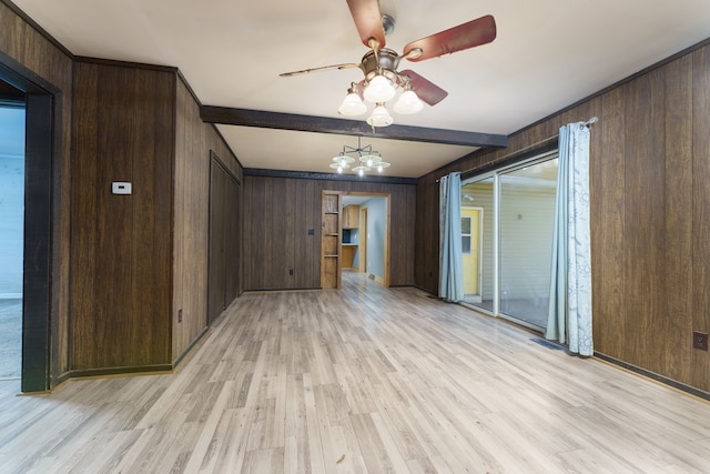 unfurnished room featuring wood walls, ceiling fan with notable chandelier, light hardwood / wood-style floors, and beam ceiling